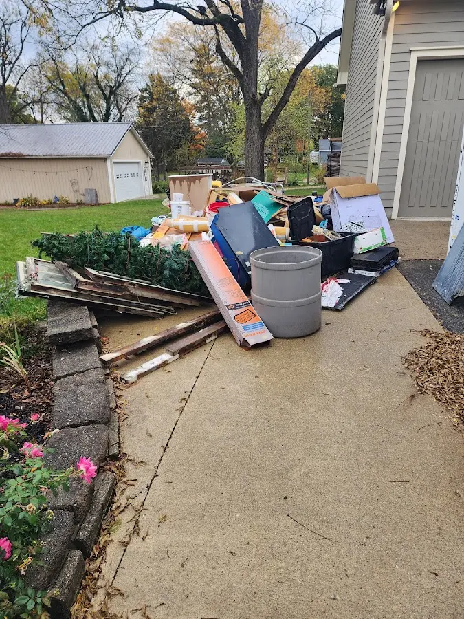 Dumpster being loaded with debris for 3 Yard Dumpster Rental in Riviera Beach